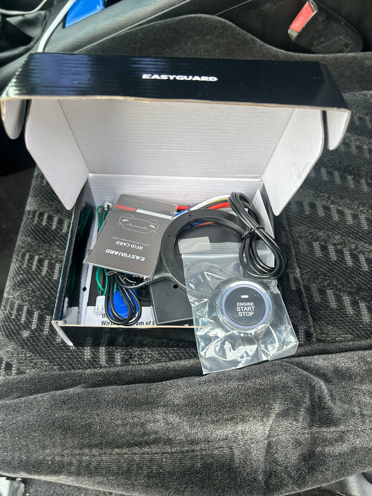 EasyGuard remote start kit in its box with the push-to-start button and wiring